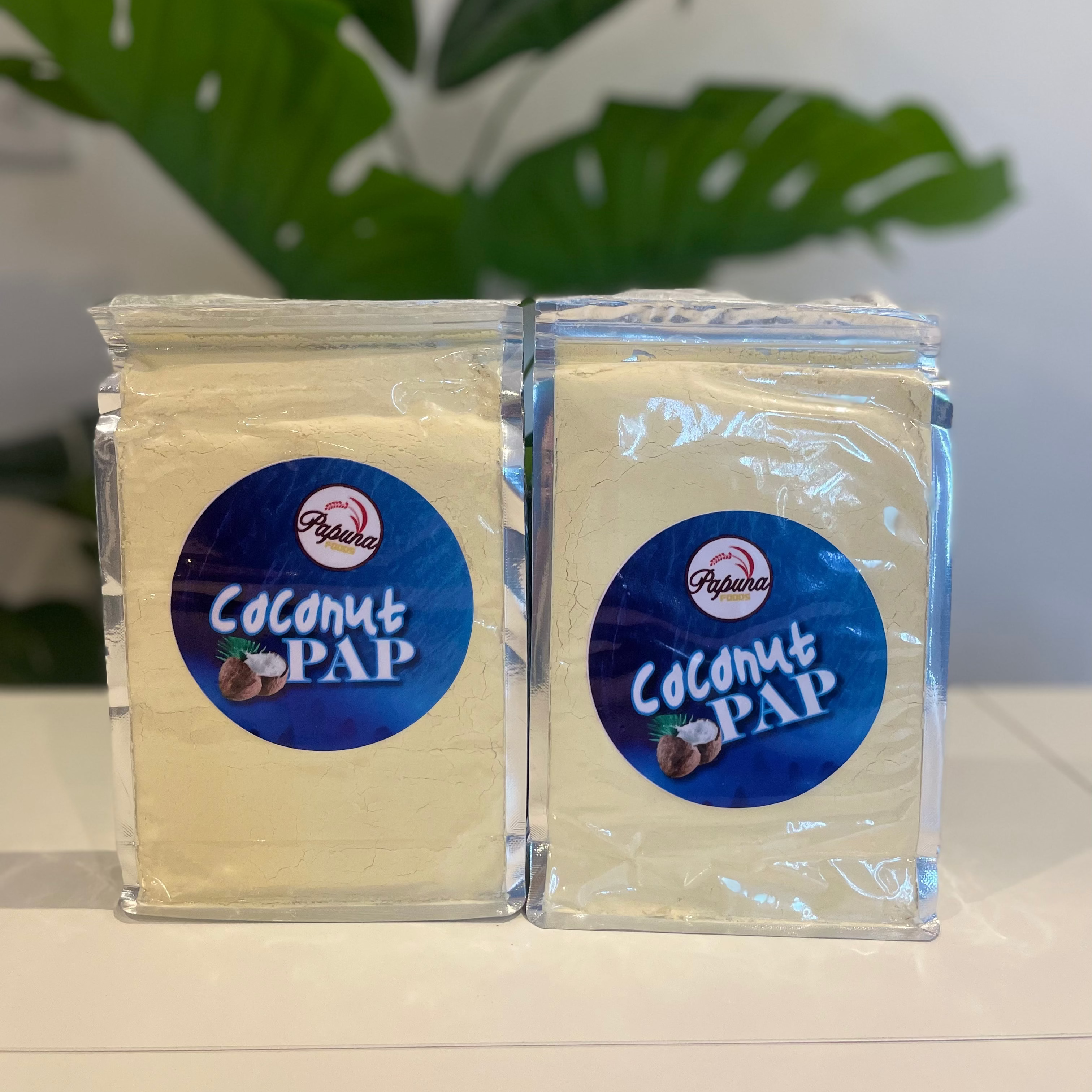  'Coconut Pap' with a blue label on a white surface.